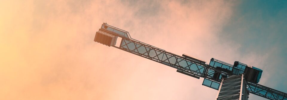 low angle photography of gray tower crane